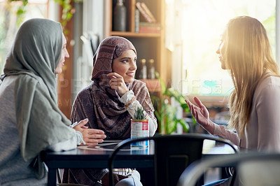 Buy stock photo Friends, smile and Muslim women in cafe, bonding and talking together. Coffee shop, happy and Islamic girls, group or people in conversation, chat and discussion for social gathering in restaurant.