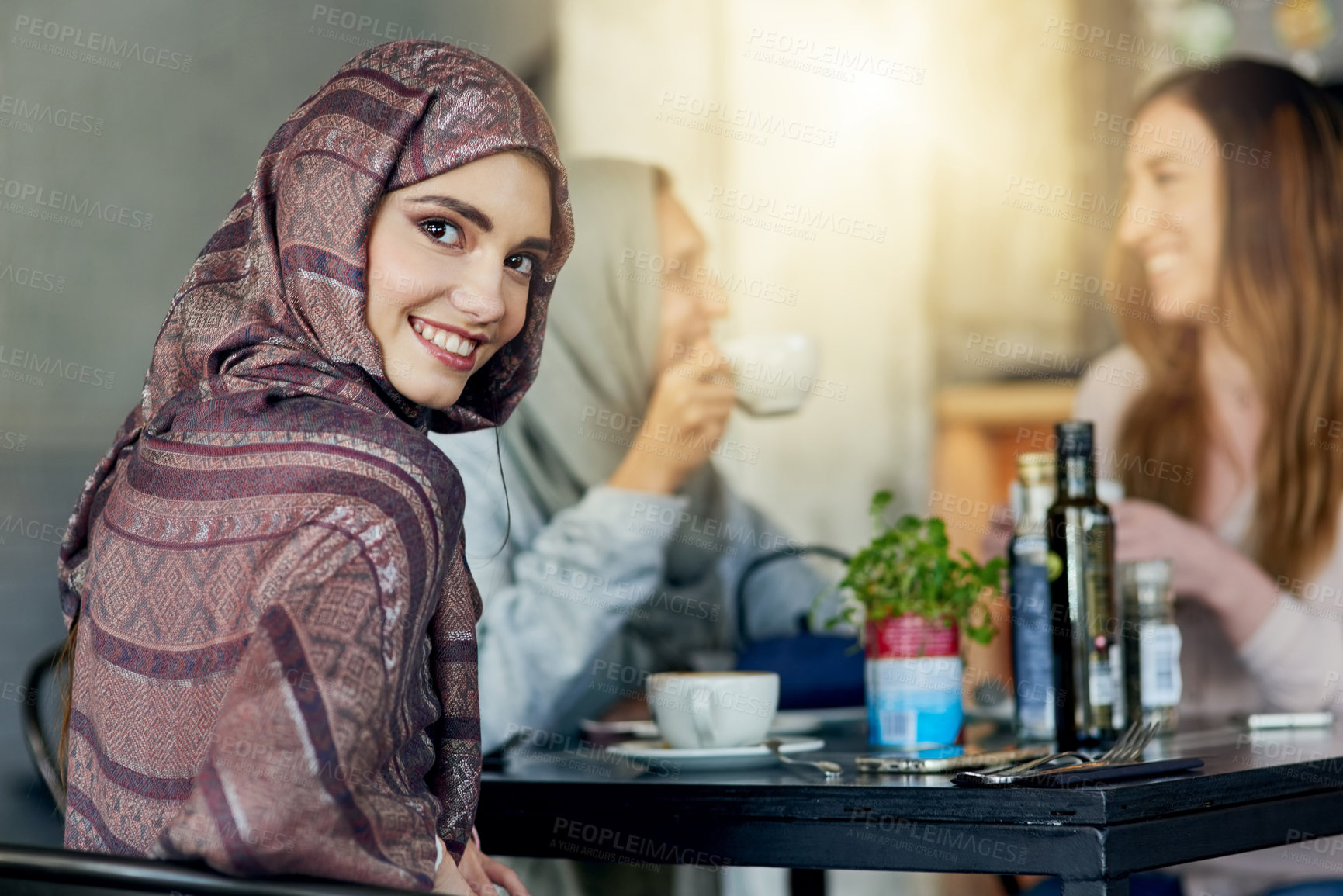 Buy stock photo Restaurant, muslim woman and portrait with friends for food, diversity and chat with lunch in Turkey. Cafeteria, females and meal of halal friendly, coffee and nutrition for eating while bonding