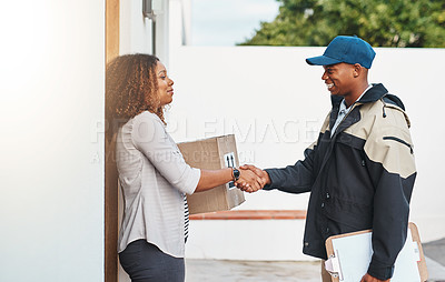 Buy stock photo Shot of a courier shaking hands with a customer while making a delivery