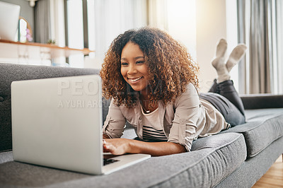 Buy stock photo Laptop, relax and happy woman typing on sofa, streaming movie or reading blog on internet in home. Living room, lying and African girl on computer for online forum, research or check email for news