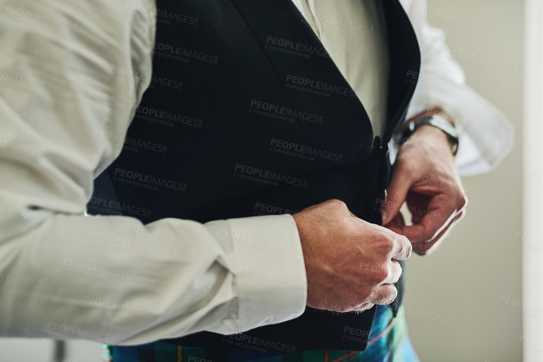Buy stock photo Shot of an unrecognizable man putting on formal clothes to get ready for a wedding inside of a building during the day