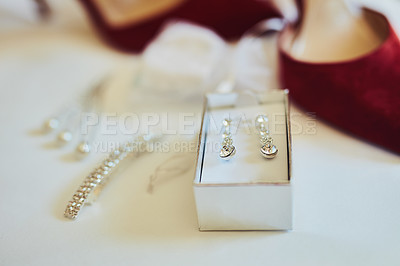 Buy stock photo Closeup of various amounts of fine elegant jewelry and a pair of red high heels resting against a white sheet