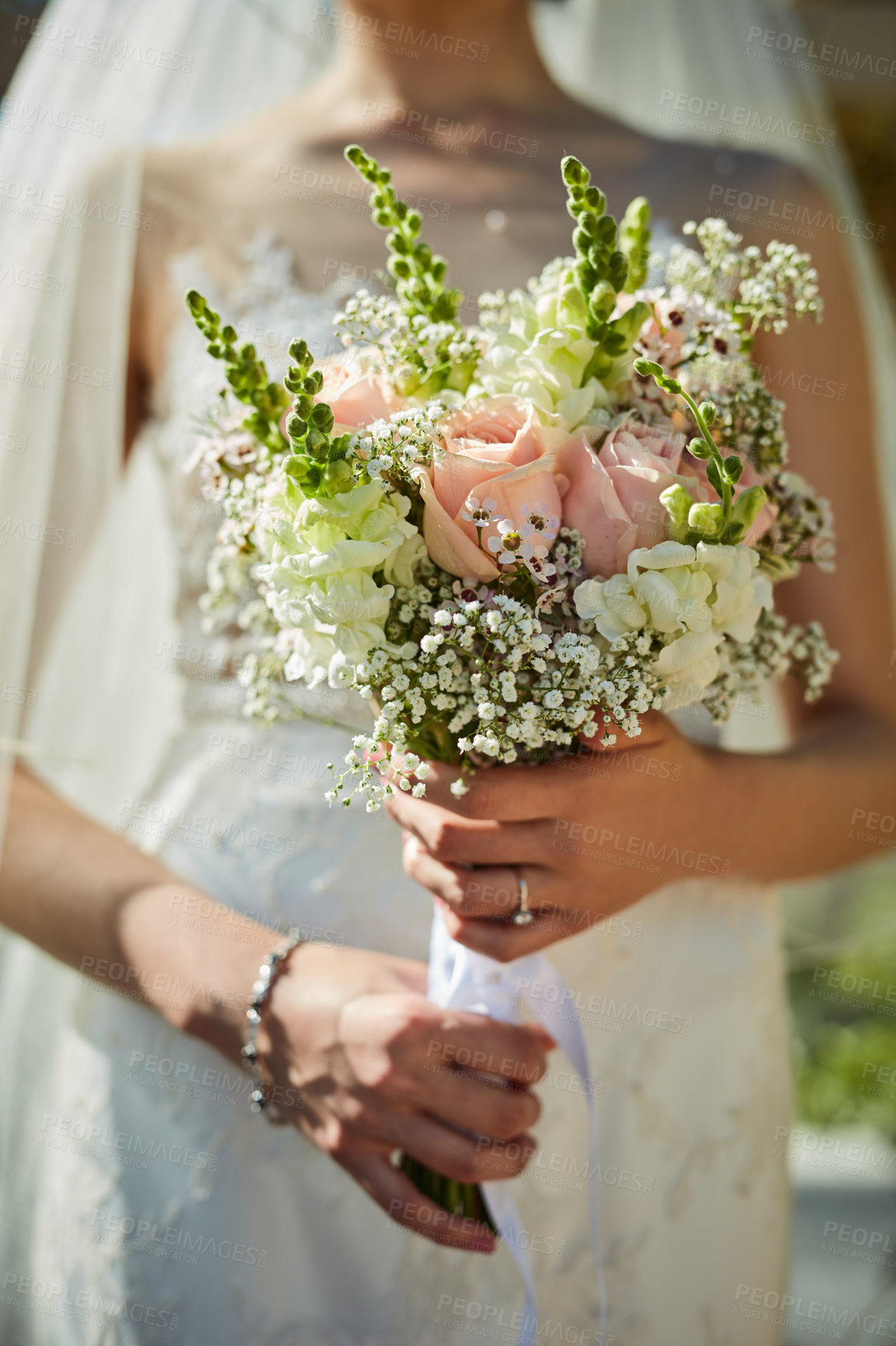 Buy stock photo Shot of an unrecognizable woman holding a bouquet of flowers at a wedding