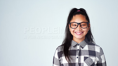 Buy stock photo Portrait, girl and kid with glasses, student and confident geek on blue studio background. Face, happy person and model with smile, joy or eyewear for clear vision, looking and mockup space with nerd