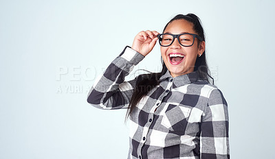 Buy stock photo Studio portrait of a cute and confident young girl posing against a gray background