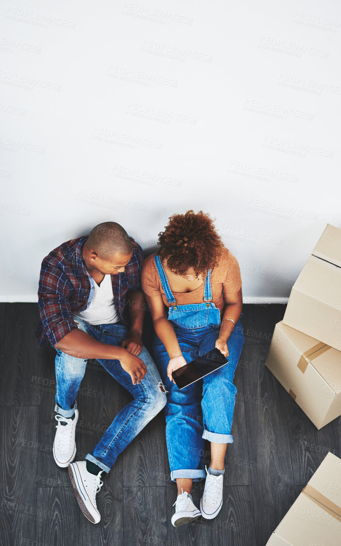 Buy stock photo High angle shot of a young couple moving house