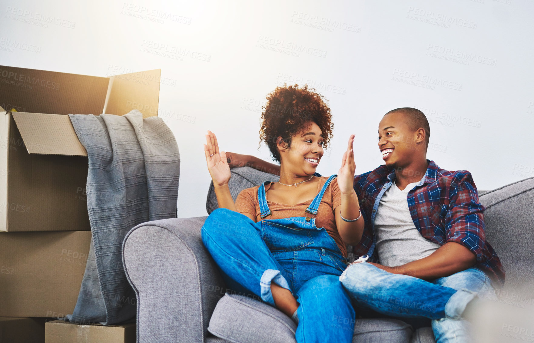 Buy stock photo Shot of an attractive young couple moving house