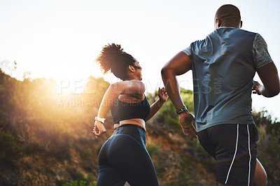 Buy stock photo Rearview shot of a young couple out running together