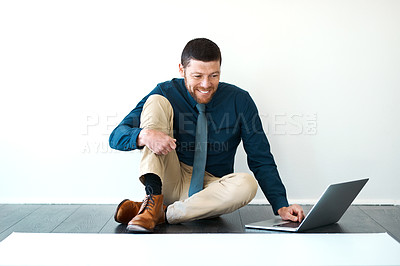Buy stock photo Full length shot of a handsome mature male architect working on his laptop