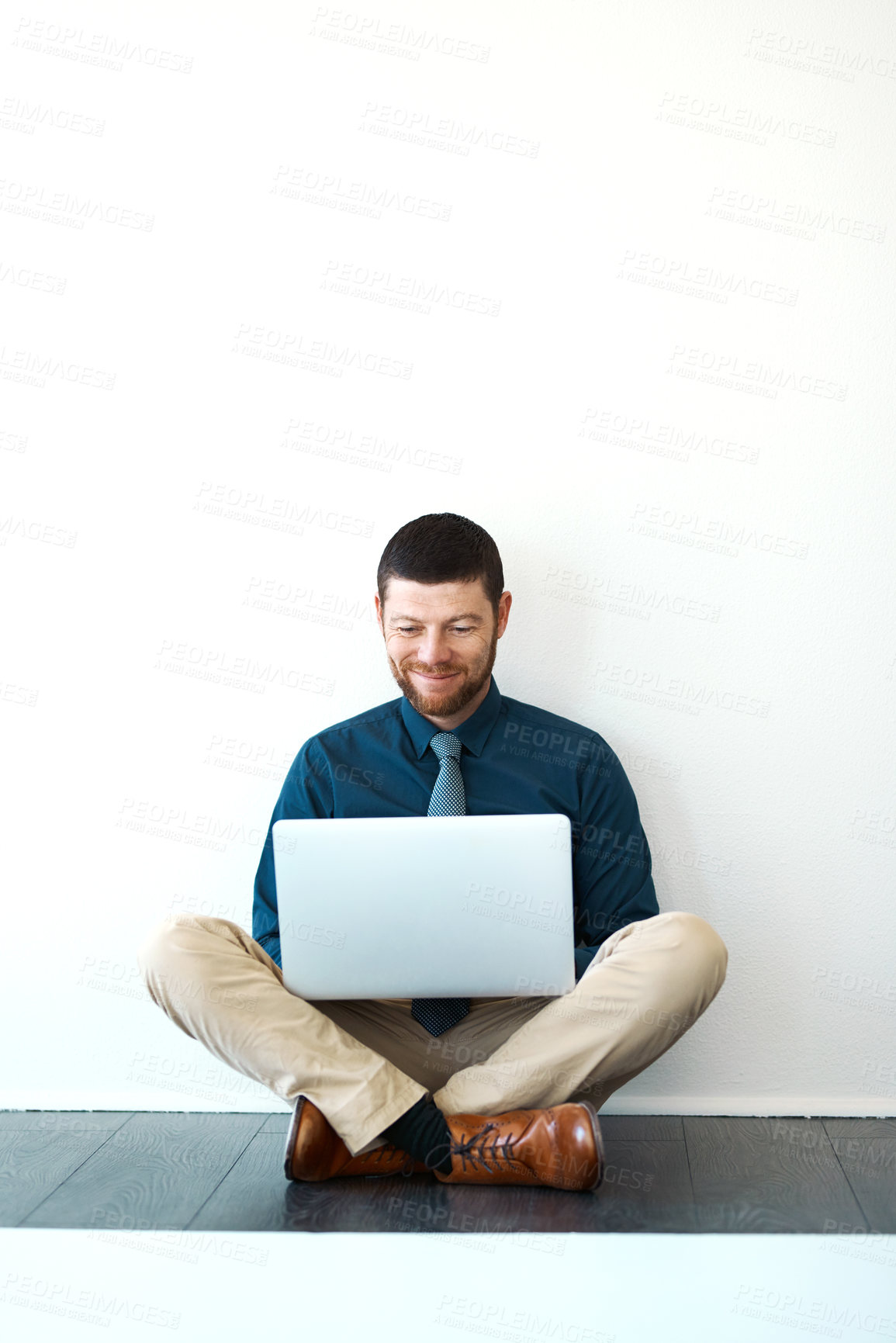 Buy stock photo Full length shot of a handsome mature businessman working on his laptop