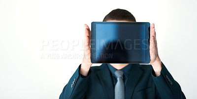 Buy stock photo Cropped shot of an unrecognizable businessman holding a digital tablet up in front of his face