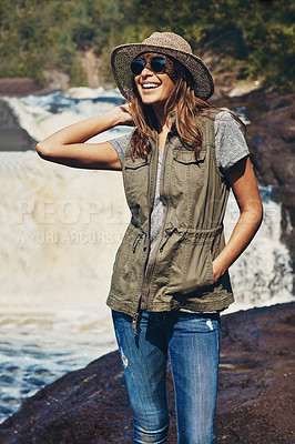 Buy stock photo Shot of an attractive young woman standing next to a rocky river