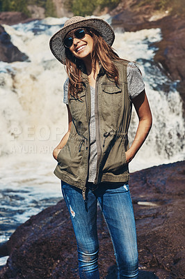 Buy stock photo Shot of an attractive young woman standing next to a rocky river