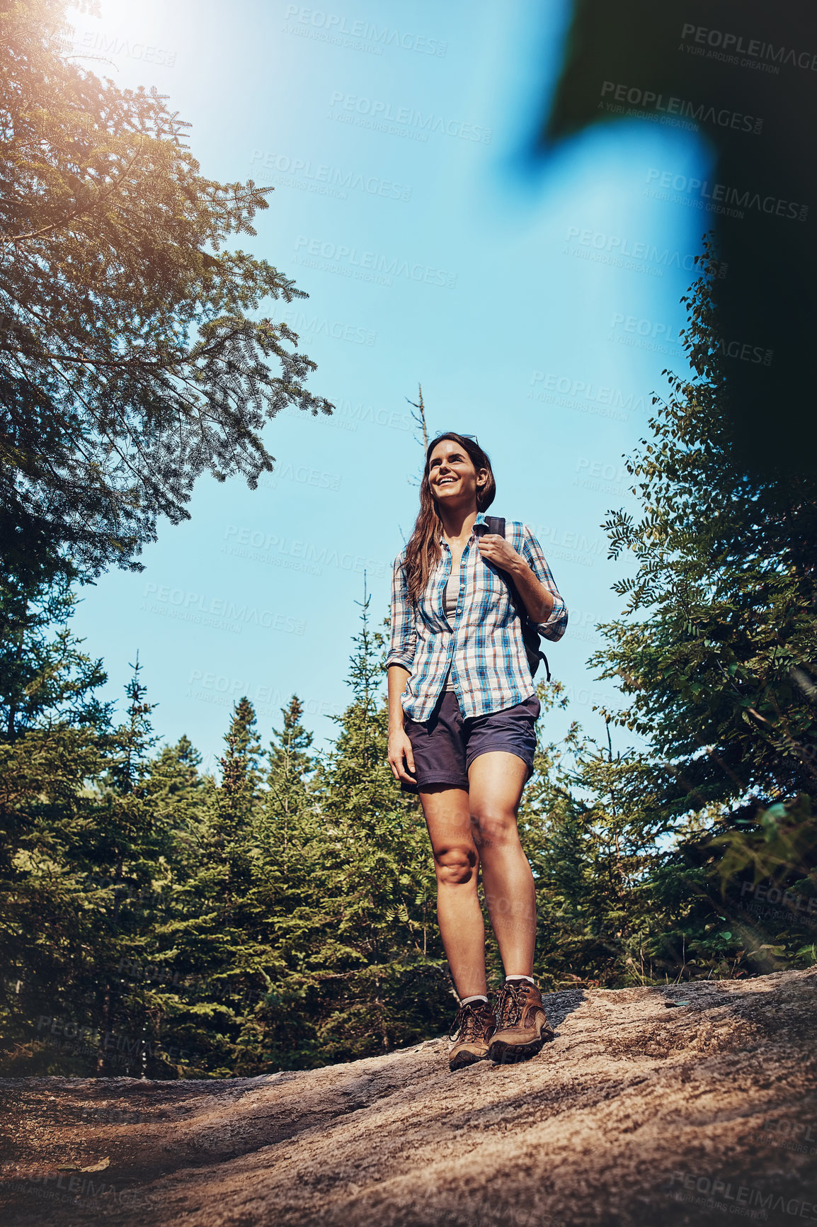 Buy stock photo Shot of a young woman going for a hike through nature