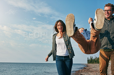 Buy stock photo Shot of a young family spending a day at the lake