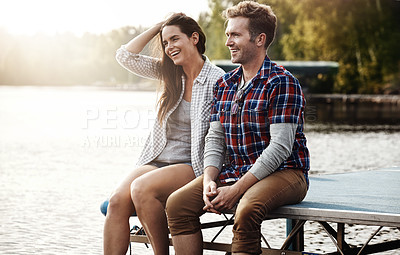 Buy stock photo Happy couple, date and relax on dock in nature for holiday, vacation and anniversary in summer. Love, people and thinking by lake for story telling, adventure or funny past memories in relationship