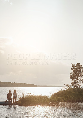 Buy stock photo Shot of a young couple going for a canoe ride on the lake