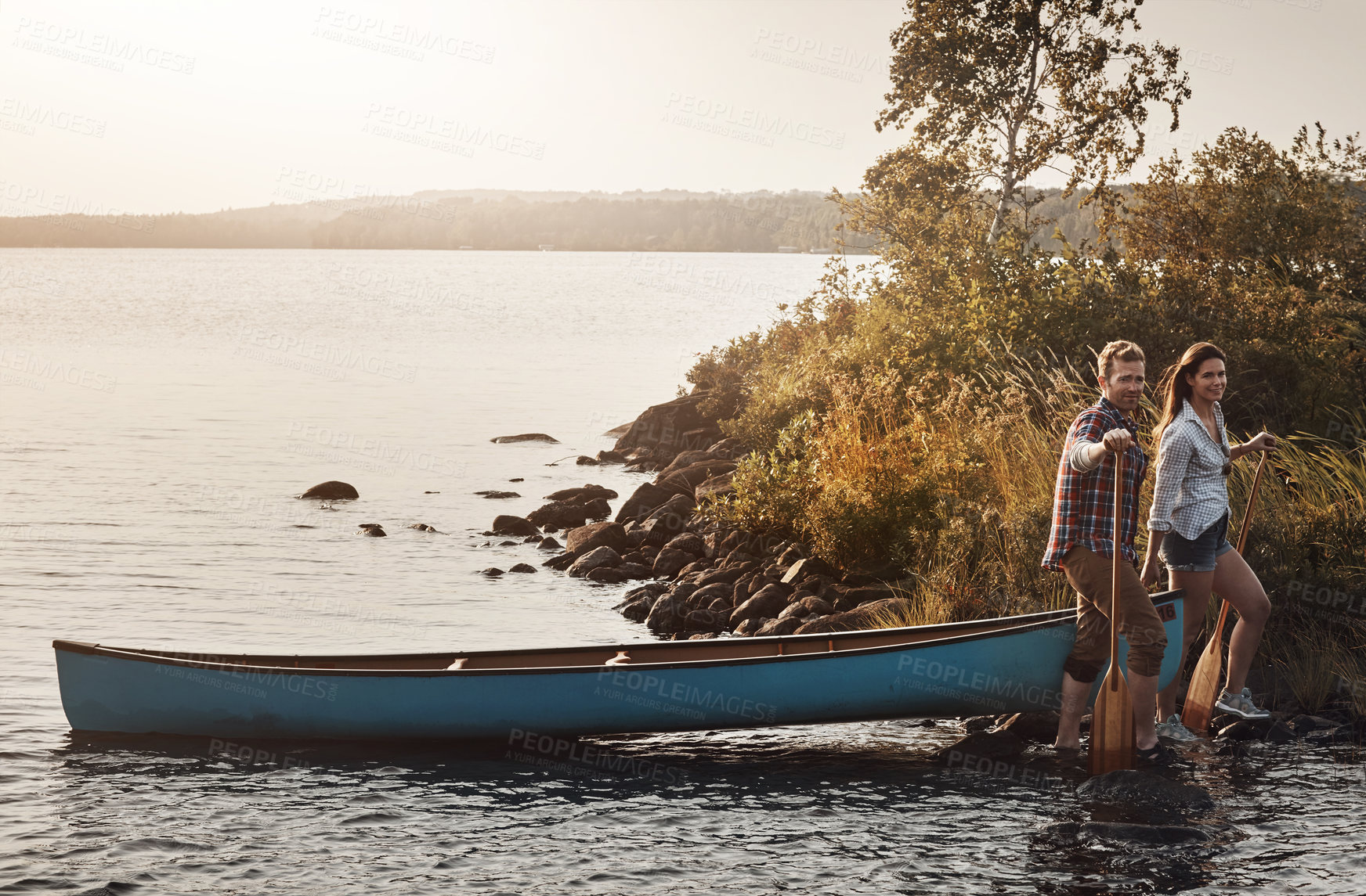 Buy stock photo Portrait of a young couple going for a canoe ride on the lake