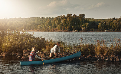 Buy stock photo Portrait of a young couple going for a canoe ride on the lake