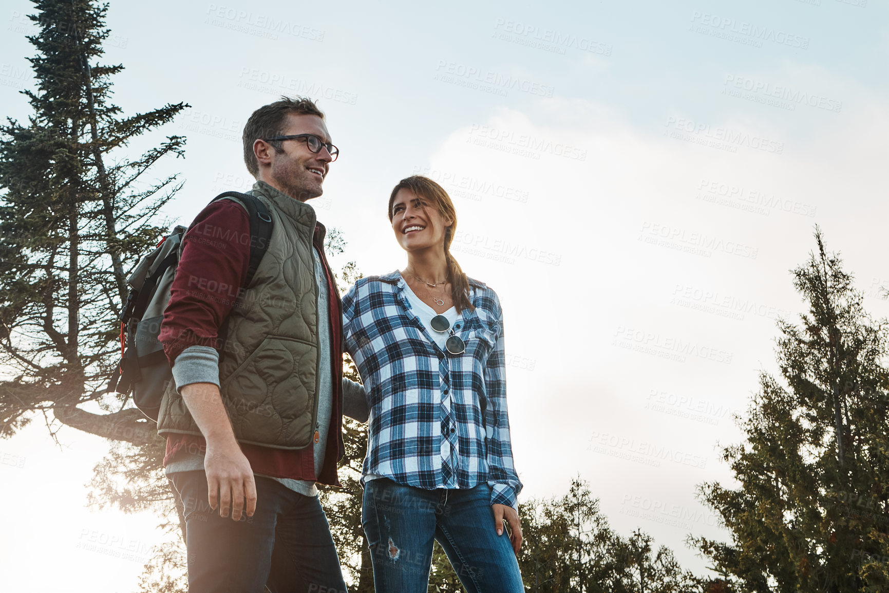 Buy stock photo Shot of a young couple exploring nature together