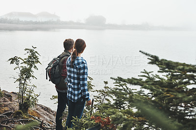 Buy stock photo Shot of a young couple exploring nature together