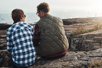 Buy stock photo Shot of a loving couple taking a break while out exploring nature