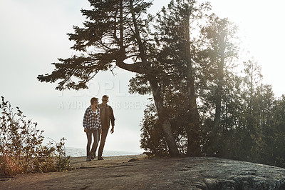 Buy stock photo Shot of a young couple out for a walk in nature