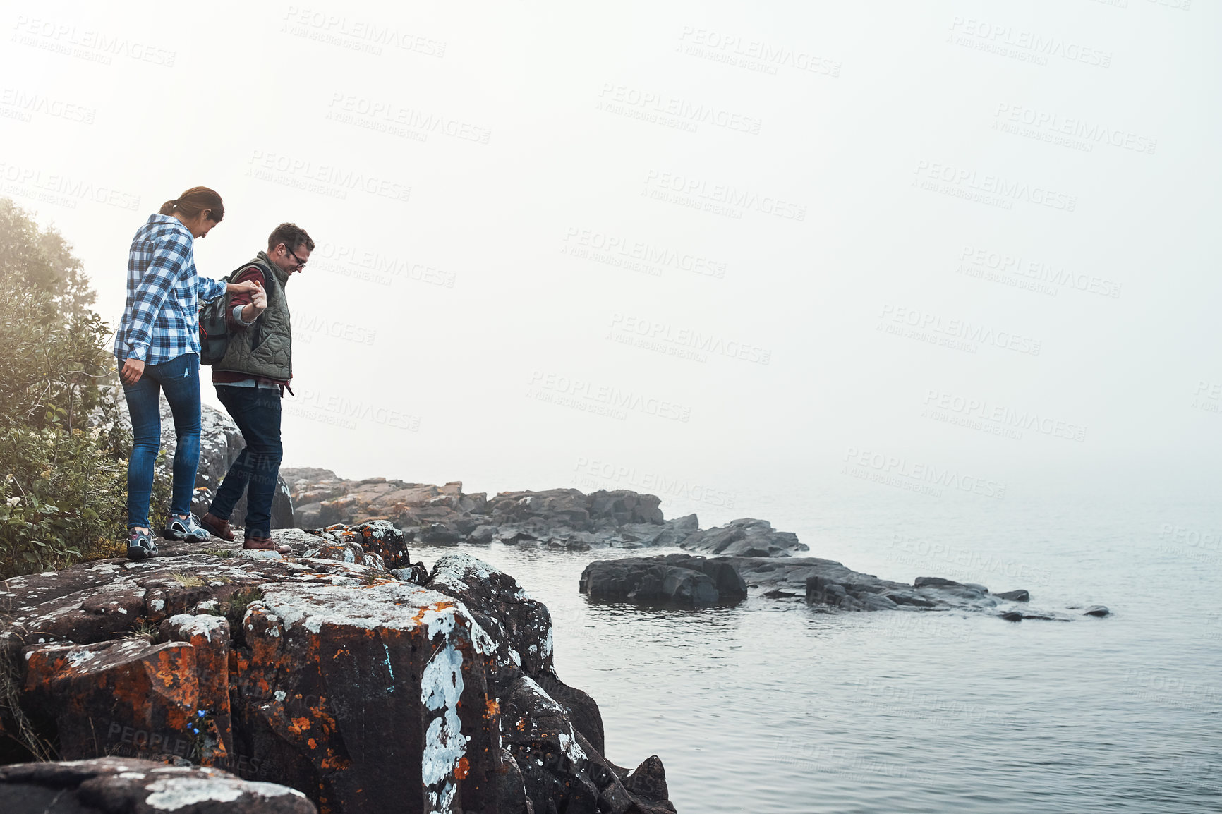 Buy stock photo Shot of a young couple exploring nature together