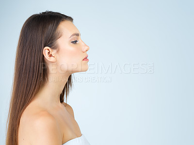 Buy stock photo Woman, profile and mockup with makeup, cosmetics and natural beauty aesthetic in a studio. Isolated, blue background and young female model with mock up for advertisement and luxury branding