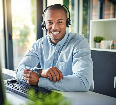 Buy stock photo Cropped shot of a young handsome male customer support agent working in the office