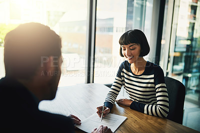 Buy stock photo Shot of two businesspeople going through paperwork in an office