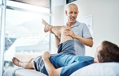 Buy stock photo Physiotherapy, men and client with recovery, leg injury and healing with wellness, relief pain and expert. People, physical therapist and customer with appointment, health or checkup with service