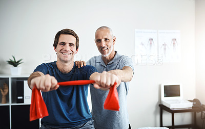 Buy stock photo Portrait of a physiotherapist helping a patient stretch with resistance bands