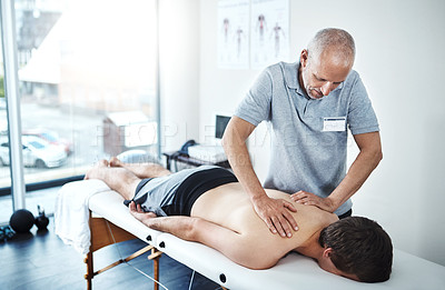 Buy stock photo Shot of a physiotherapist treating a patient