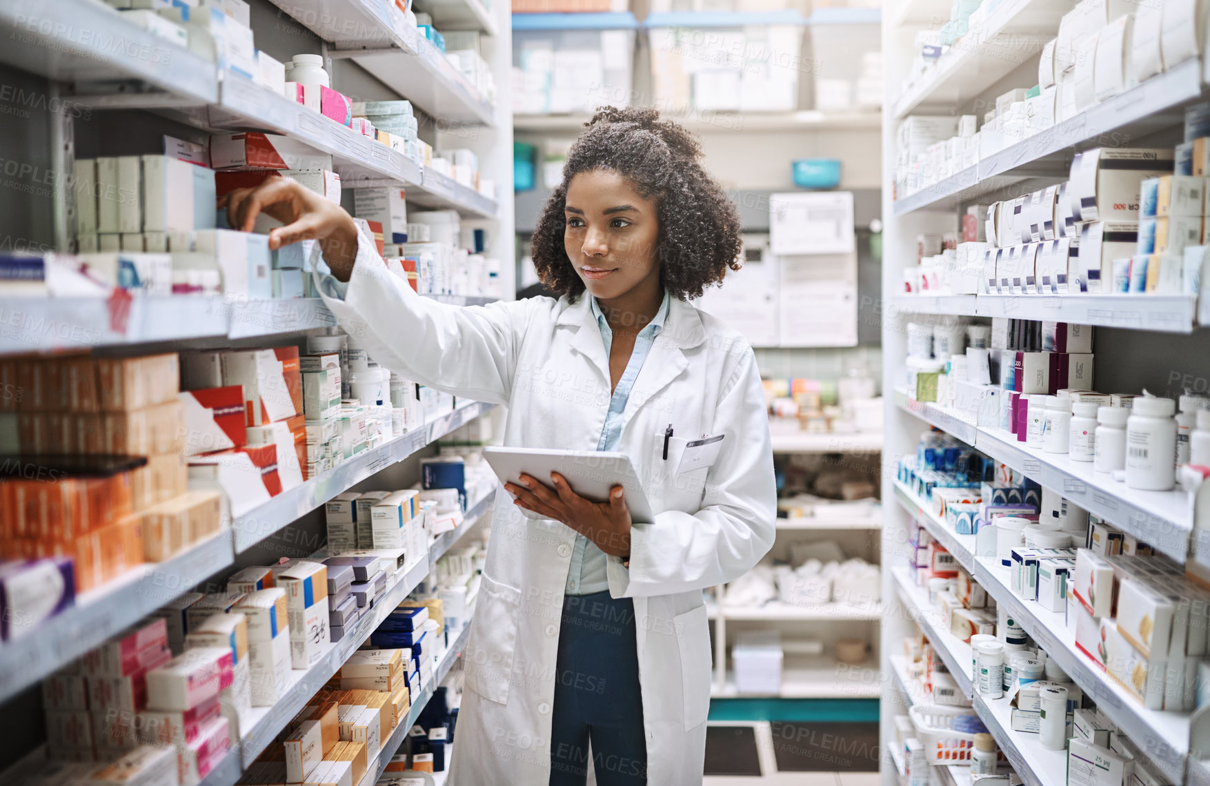 Buy stock photo Cropped shot of an attractive young female pharmacist working in a pharmacy