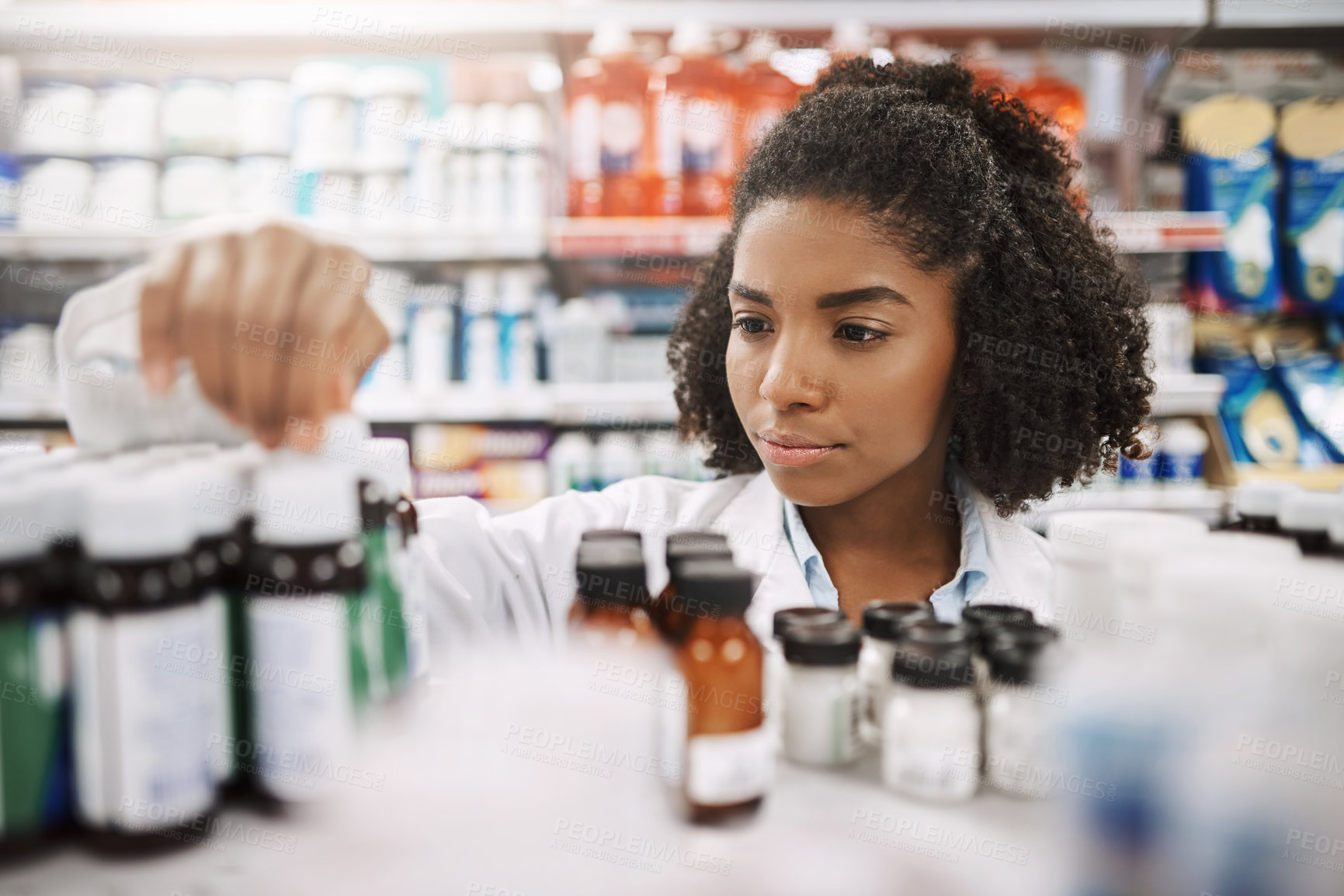 Buy stock photo Pharmacy, healthcare and black woman for inventory, serious and reading for safety of medicine and info. Shop, pharmacist and check of label, product and process of prescription, service and person