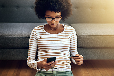 Buy stock photo Black woman, phone and credit card for ecommerce, payment or purchase in living room at home. African female person or shopper sitting on floor with smartphone or debit for online shopping or banking