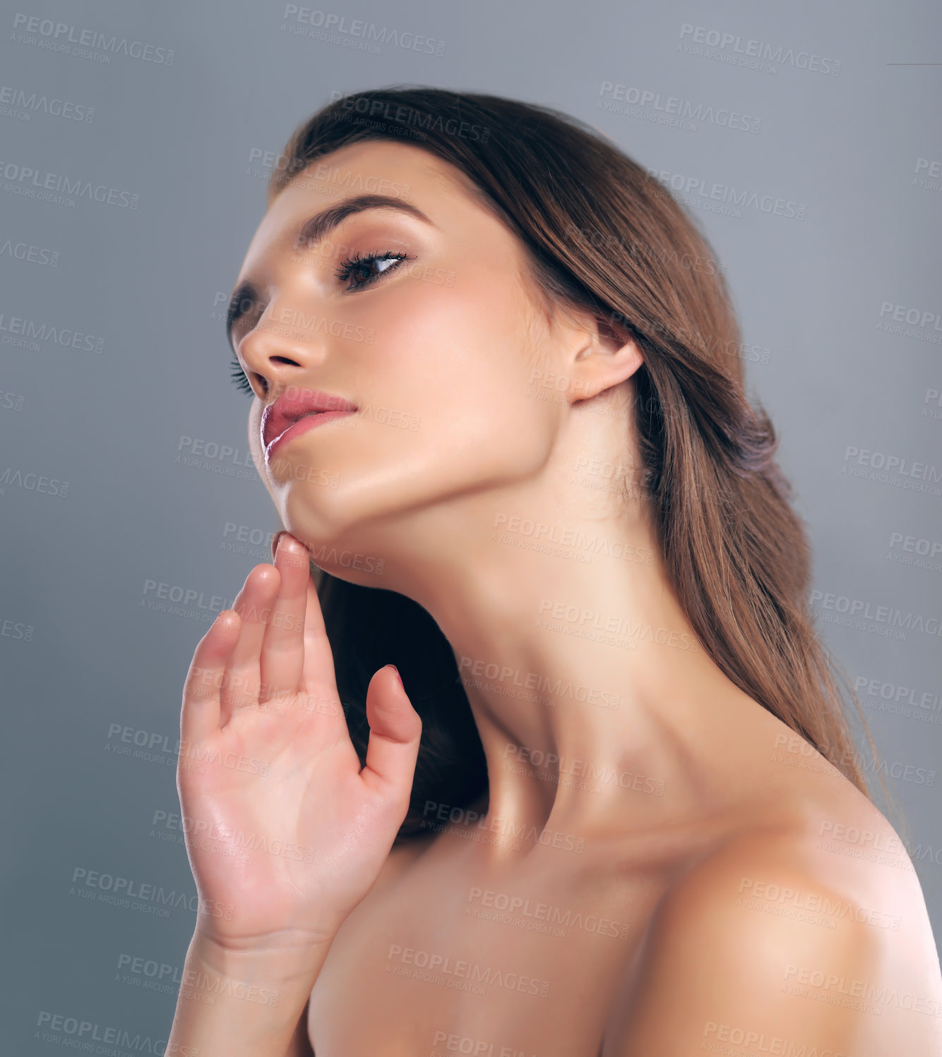 Buy stock photo Studio shot of a beautiful young woman posing against a gray background