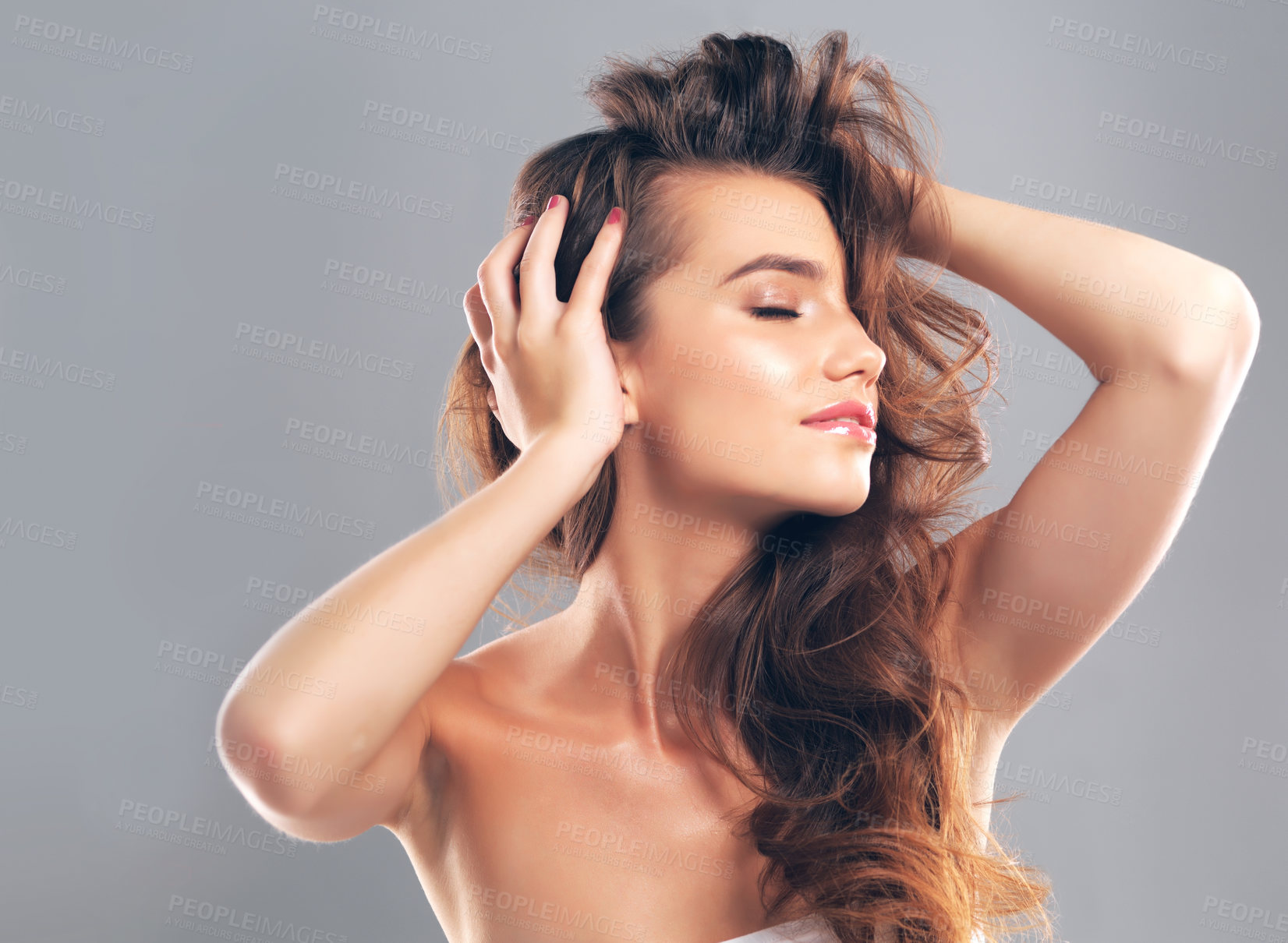 Buy stock photo Studio shot of a beautiful young woman posing against a gray background