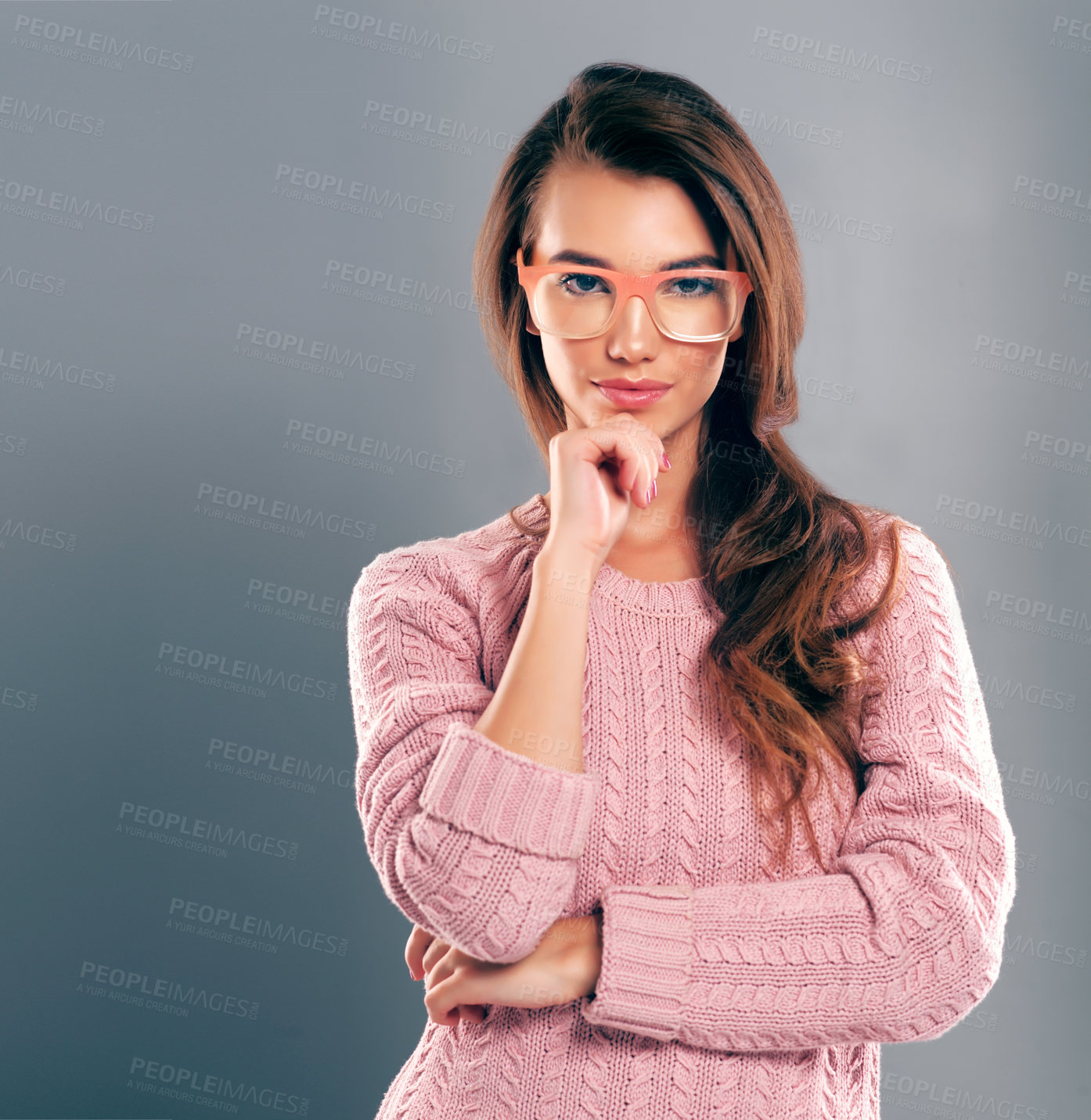 Buy stock photo Studio shot of a beautiful young woman posing against a gray background