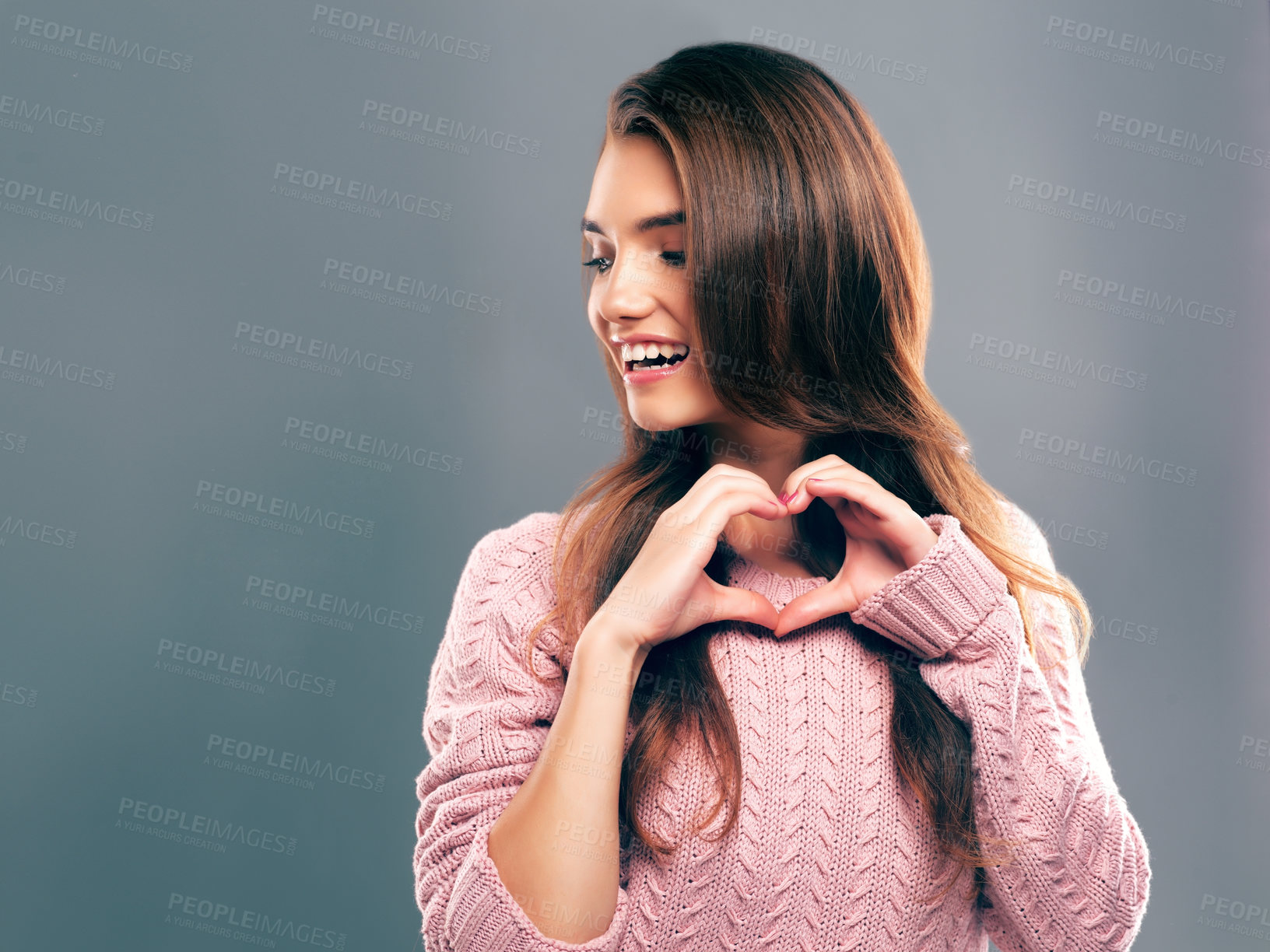 Buy stock photo Studio shot of a beautiful young woman posing against a gray background