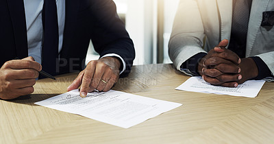 Buy stock photo Closeup shot of two unidentifiable businessmen going through paperwork in an office