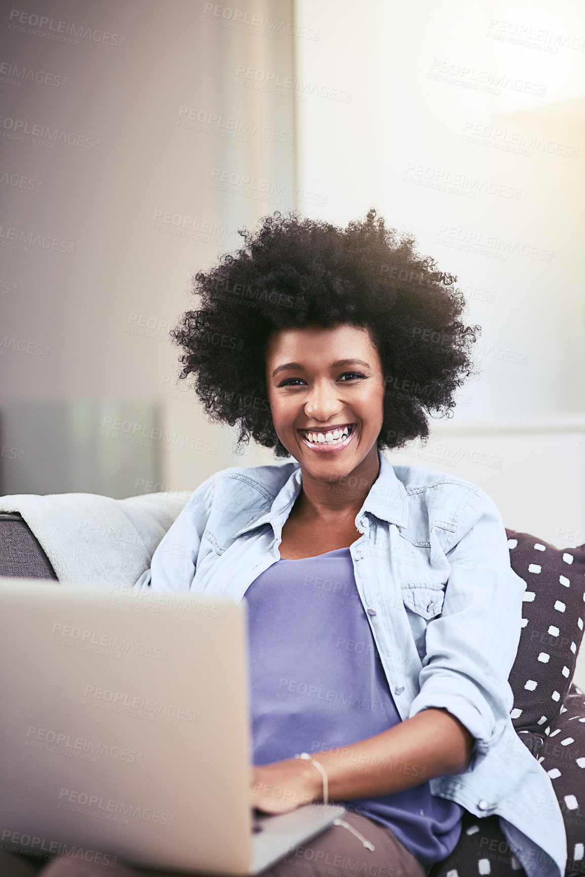Buy stock photo Shot of a young woman using a laptop on the sofa at home