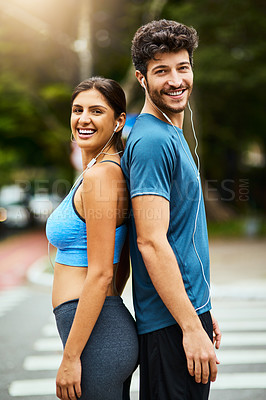 Buy stock photo Portrait of a sporty young couple exercising together outdoors