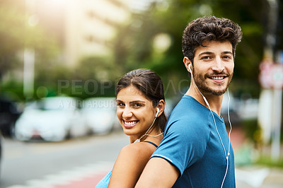 Buy stock photo Portrait of a sporty young couple exercising together outdoors
