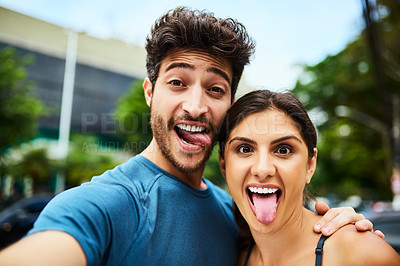 Buy stock photo Portrait of a sporty young couple taking a selfie together outdoors