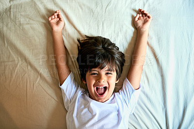 Buy stock photo Child, boy and stretching portrait in bed for wake up, new day and well rested in bedroom of home. Kid, excited and resting on sheets in house for weekend energy, happy and holiday with shouting