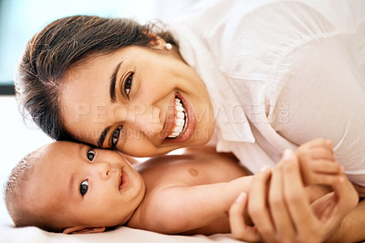 Buy stock photo Shot of a happy mother bonding with her baby boy at home