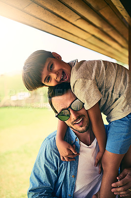 Buy stock photo Cropped portrait of a happy young father and son outside in their yard