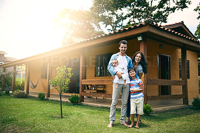 Buy stock photo Full length portrait of a happy young family of four outside with their house in the background